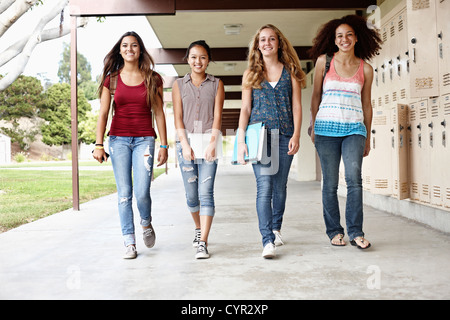 School friends walking in portico Stock Photo