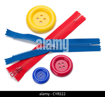 Three colored sewing buttons and two zippers. Isolated on white Stock Photo