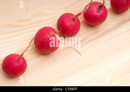 fresh red raw raddish over pine wood table closeup Stock Photo