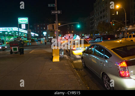 November 8, 2012, New York, NY, US.  Hours before gas rationing is to begin in New York City, drivers lined up to fill their tanks at a Hess petrol station in Hell's Kitchen. Stock Photo