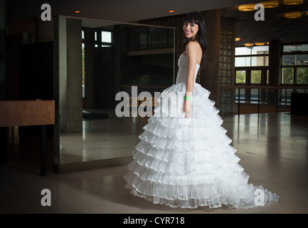 Young bride posing with wedding dress in interior Stock Photo
