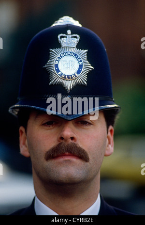 A close-up detail of a London Metropolitan police officer's face and helmet. Stock Photo