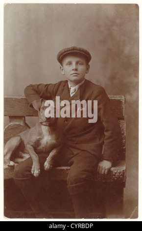 Original studio portrait of Edwardian boy with his pet terrier dog, posted from Dartmouth, Devon, U.K. dating from the early 1900's, between 1902-1906 Stock Photo