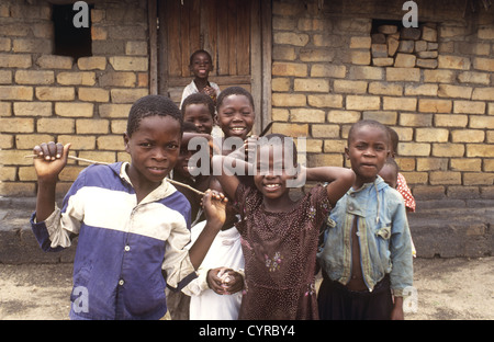 Children pose together for the camera in a typical village setting - Nkhotakota, Lake Malawi, Malawi Stock Photo