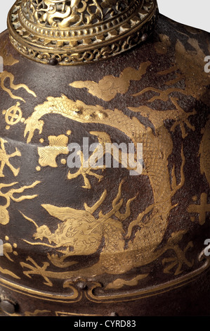 A Chinese gold-inlaid helmet for a member of the Imperial family,Qing Dynasty,18th century One-piece iron skull with two surrounding ridges and a riveted lower rim.The exterior embellished by a frieze of five gold-inlaid dragons,their feet with five claws.Riveted ornamentally pierced visor,the crown's apex of gilt brass.Six rivets for the(missing)neck-guard at the rear edge.The detachable iron trident finial old,but probably not associated.Height without finial 28.5 cm.Extremely rare,beautifully preserved helmet.As the depiction of five-clawed dr,Additional-Rights-Clearences-Not Available Stock Photo