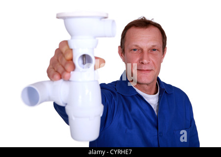 Plumber holding replacement part Stock Photo