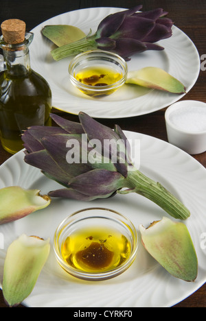 Artichoke with dipping sauce (oil, salt, pepper and vinegar) Stock Photo