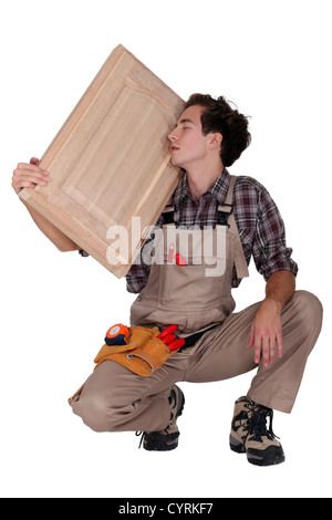 carpenter holding a wooden window Stock Photo