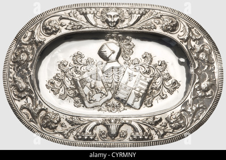 Hermann Göring,an elaborate silver dish,a present from a Spanish nobleman Hand-hammered silver decorated in high relief.Oval form,the border decorated with blossoms,scrolling foliage,cornucopiae,and mascarons.The centre shows the combined coat of arms of the Cangas family of Asturias and a coat of arms bearing the colours of the Valdés family in the second and third quarter of the shield.Master's mark 'S.Gonzalez' and Spanish hallmarks.Ca.63 x 43 cm,weight 1498 g.Provenance: 'Freiwillige Versteigerung aus dem ehemaligen Besitz von Hermann Göring',,Additional-Rights-Clearences-Not Available Stock Photo