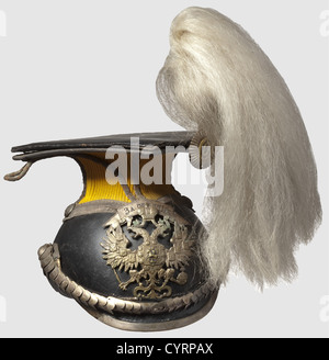 A Czapka for officers,of the 8th Voznesensky Uhlan Regiment of Grand Duchess Tatiana Nikolaevna Russia circa 1910. Leather body with silvered fittings. The device with a bandeau in Cyrillic letters(tr)'For Distinction'. Convex chin scales with Russian stamping 'N 1,D. Sch' and velvet underlining. Yellow parade cover with silver officerïs cord,beneath the cover continuous silver braid. Metal cockade,white horsehair plume. Black leather sweat band. Replaced linen liner. Traces of past usage,historic,historical,1910s,20th century,uniform,uniforms,head,Additional-Rights-Clearences-Not Available Stock Photo