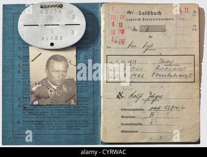 Knight's Cross winner Dr. Rolf Jäger (1912 - 1984), a Soldbuch (pay document) and an identification disc The Soldbuch proceeds in an orderly manner with entries from 26 August 1939 until the final entry on 1 May 1946, while in British captivity. Full of entries, for example in regards to awards: Commemorative Medal of 1 October 1938, Long Service Award 4th Class, Iron Cross 2nd and 1st Class of 1939, Knight's Cross of the Iron Cross, Luftwaffe Ground Combat Badge, War Merit Cross 2nd and 1st Class with Swords. After the war, and while in British captivity, Jäge, Stock Photo