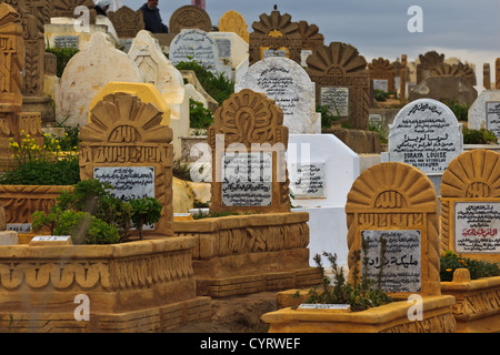 Variety of ornate, colorful headstones with inscriptions in a crowded traditional Muslim cemetery Rabat, Morocco. Stock Photo