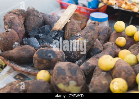 Close-up of sweet potatoes with lemons at a chaat stall, New Delhi, India Stock Photo