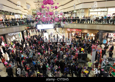 Crowds and decorations at the switch on of Queensgate shopping centres Christmas lights, Peterborough, Cambridgeshire, England. 08 11 2012 Stock Photo