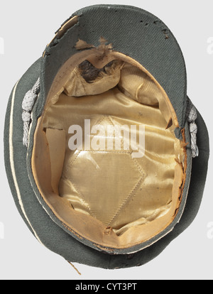 An old style visor cap,for officers of the Waffen-SS Cap with cloth visor of fine field grey gabardine with black velvet cap band,white piping,silver cord. The light brown silk inner liner with salino,the leather sweat band damaged. Replaced aluminium insignia with vestiges of silvering(missing pins). The cap with signs of usage and moth damage. An extremely rare cap,historic,historical,1930s,1930s,20th century,Waffen-SS,armed division of the SS,armed service,armed services,NS,National Socialism,Nazism,Third Reich,German Reich,Germany,milit,Additional-Rights-Clearences-Not Available Stock Photo