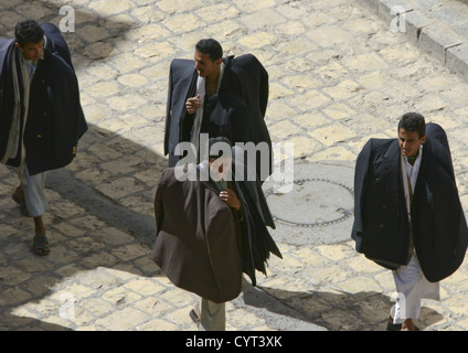 Clothes Sellers Passing By With All Their Stock In The Souq, Sanaa, Yemen Stock Photo