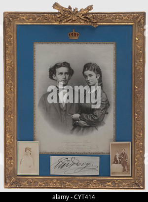 King Ludwig II of Bavaria and Duchess Sophie in Bavaria, an engagement portrait on silk, 1867 Lithograph on silk, entitled, 'König Ludwig II. Von Bayern mit Allerhöchstdessen Braut Sophie Charlotte, Herzogin in Bayern' (King Ludwig II of Bavaria with His Supreme Highness's Fiancée Duchess Sophie in Bavaria) on the lower edge. Light blue passpartout, (dimensions of the visible picture ca 32 x 23 cm) with a gold edge and royal crown overlay. Framed under glass in a gilt plaster frame with rocaille decoration in relief and decorative trophies along the top. Framed, Stock Photo