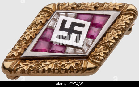 Adolf Hitler,a golden Hitler Youth Honour Badge with brilliants and rubies in an oak leaf wreath Gold(hallmark '585'),platinum,brilliants and rubies. No maker's mark. In a light-blue leather case with white velvet and silk lining. Included is the document tube for the award document,a white leather cylinder with stamped National Eagle above a Hitler Youth emblem and continuous gold-stamped meander bands. The tube is in its corresponding oak wooden casket with brown v historic,historical,1930s,20th century,NS,National Socialism,Nazism,Third Reich,Ge,Additional-Rights-Clearences-Not Available Stock Photo