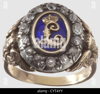 King Ludwig II of Bavaria(1845-1886),a diamond set gift ring for a distinguished Munich citizen Red gold,blue enamelled centre with applied gold cypher "L",the hoop of white gold,set with 14 old European cut diamonds,the shoulders embellished with cupids and decorations. The inside of the ring stamped "585". Large ring size for men. Weight 10.8 g. The ring comes from private ownership(further details provided to the buyer if desired)and has never been on the market before,a used piece of jewellery of strong appeal,historic,historical,19th century,B,Additional-Rights-Clearences-Not Available Stock Photo