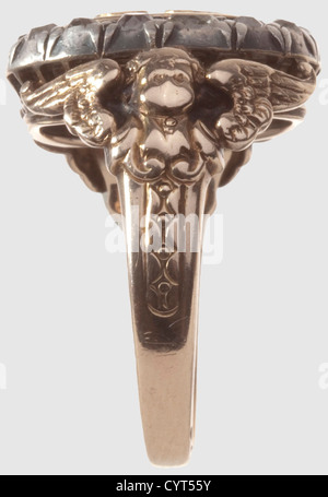 King Ludwig II of Bavaria(1845-1886),a diamond set gift ring for a distinguished Munich citizen Red gold,blue enamelled centre with applied gold cypher "L",the hoop of white gold,set with 14 old European cut diamonds,the shoulders embellished with cupids and decorations. The inside of the ring stamped "585". Large ring size for men. Weight 10.8 g. The ring comes from private ownership(further details provided to the buyer if desired)and has never been on the market before,a used piece of jewellery of strong appeal,historic,historical,19th century,B,Additional-Rights-Clearences-Not Available Stock Photo