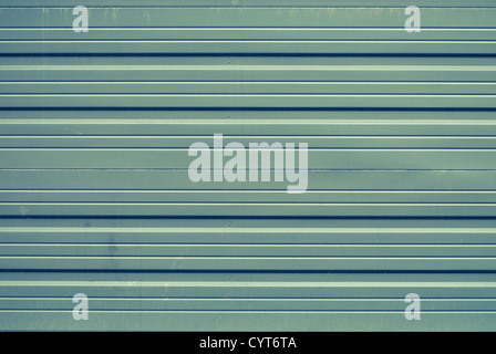 A flat green garage door with a little rust. Stock Photo