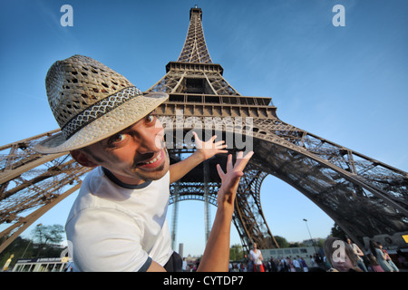 Happy smiling tourist pointing to Eiffel Tower in Paris, France. Stock Photo