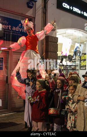 Bristol, UK. 9th November 2012. A procession of Lost Boy drummers and 150-strong procession of youth theatre school children dance their way from The Galleries to Cabot Circus. Bristol-based Cirque Bijou featuring acrobatics, stilt walkers and jugglers entertain crowds before the Christmas lights are illuminated. Stock Photo