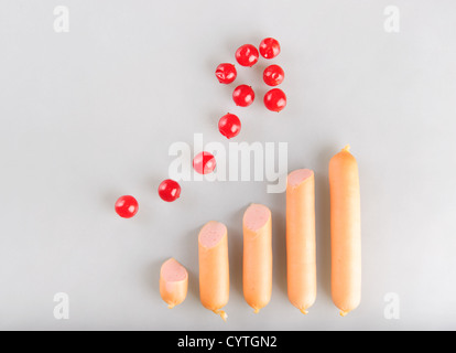 Food consumption growth trend via arranged sausages graph Stock Photo
