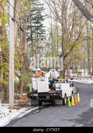 USA, 9 November 2012: Sandy Day 11 - Crews from across America lend a hand in Westchester County NY. Jimmy Libby of E&E Electrical Inc. came from Boston Massachusetts  to help the utility company Con Edison after Hurricane Sandy. He prepares to go up in a bucket to repair power lines on Brevoort Road in Chappaqua New York for residents who have been without heat and electricity for 11 days. © 2012 Marianne A. Campolongo. Stock Photo