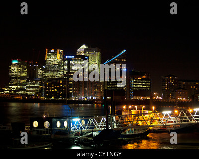 Night view of Canary Wharf skyline from Trinity Buoy Wharf showing the River Thames in foreground, London, England, UK Stock Photo