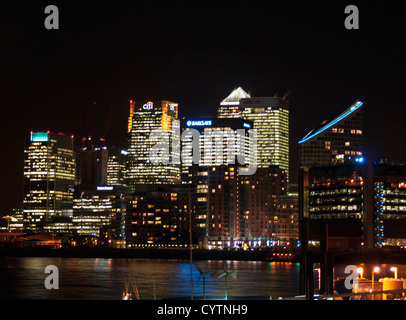 Night view of Canary Wharf skyline from Trinity Buoy Wharf showing the River Thames in foreground, London, England, UK Stock Photo