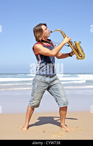 Saxophone player playing at the beach Stock Photo