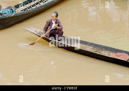 Elderly woman arriving at Inle lake market Stock Photo