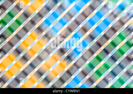 Abstract fuzzy background with grey, blue, green and orange colours. Geometric shapes: bright square lights and diagonal lines. Stock Photo