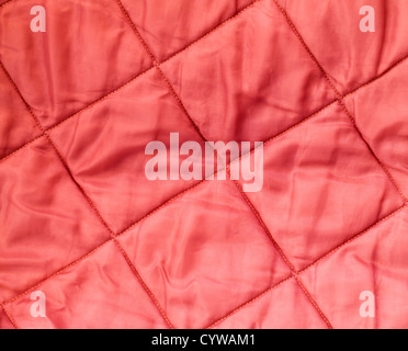 Closeup background texture of quilted red blanket fabric Stock Photo