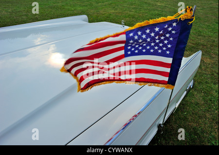 Closeup of an American flag flying on a Ca.1950s era American car. Motion blur on the flag Stock Photo