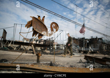 Nov. 10, 2012 - Breezy Point, New York - A uniformed officer walks through Breezy Point, New York on Saturday November 10, 2012 nearly two weeks after Hurricane Sandy devastated the area. (Credit Image: © Nicolaus Czarnecki/ZUMAPRESS.com) Stock Photo