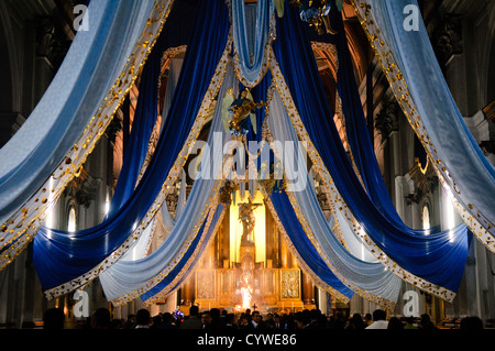 A religious ceremony takes place at night inside the Iglesia San Francisco (St. Francis Church) in downtown Guatemala City. Stock Photo