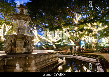 ANTIGUA GUATEMALA, Guatemala — Parque Central (or Plaza Central), the main town square in Antigua Guatemala., at night. Famous for its well-preserved Spanish baroque architecture as well as a number of ruins from earthquakes, Antigua Guatemala is a UNESCO World Heritage Site and former capital of Guatemala. Stock Photo