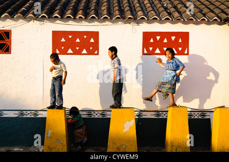 ANTIGUA GUATEMALA, Guatemala — Guatemalan children playing. Famous for its well-preserved Spanish baroque architecture as well as a number of ruins from earthquakes, Antigua Guatemala is a UNESCO World Heritage Site and former capital of Guatemala. Stock Photo