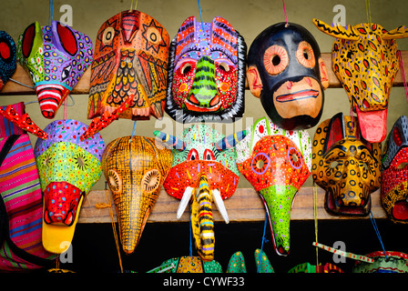 CHICHICASTENANGO, Guatemala - Colorful wooden masks for sale at Chichi's market. The town has become famous for its wooden carved masks that were originally part of local Maya celebrations and festivals. Chichicastenango is an indigenous Maya town in the Guatemalan highlands about 90 miles northwest of Guatemala City and at an elevation of nearly 6,500 feet. It is most famous for its markets on Sundays and Thursdays. Stock Photo