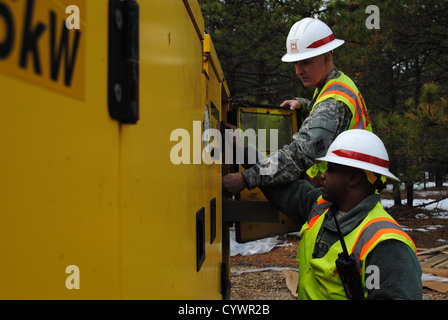 U.S. Army Sgt. William Davenport, a Baltimore, M.D., native, and Sgt. Wayne Myers, a Los Angeles, C.A., native, of Delta company 249 Engineers, Fort Belvoir, V.A., trouble shoot a generator at Lakehurst, N.J., Nov. 10, 2012. The two are supporting FEMA's Stock Photo