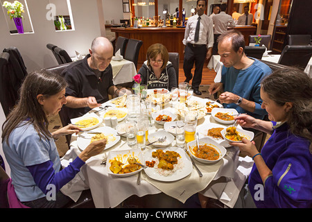 Group of people eating curry in an Indian restaurant, Burnley, England, UK Stock Photo