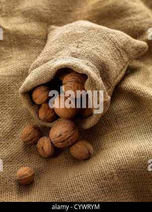 walnuts in woven bag on woven cloth Stock Photo