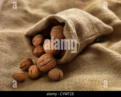 walnuts in woven bag on woven cloth Stock Photo