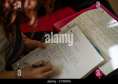 Pupils writing in their workbooks at a comprehensive secondary school Wales UK Stock Photo