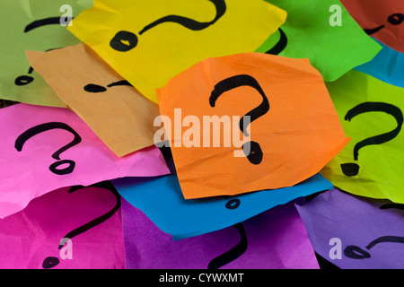 questions, decision making or uncertainty concept - a pile of colorful crumpled sticky notes with question marks Stock Photo