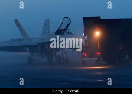 F/A-18 Hornet fighter being refueled at night. Stock Photo