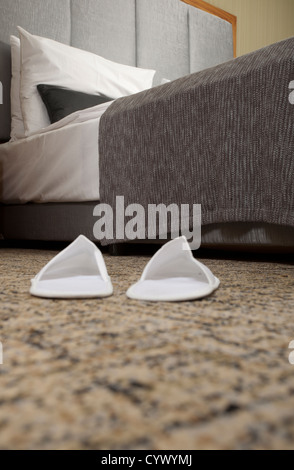 Slippers on the floor of hotel room Stock Photo