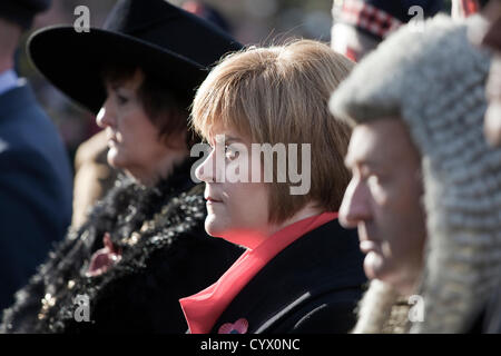 11 November 2012, Remembrance Day Parade, George Square, Glasgow, Scotland. Nicola Sturgeon, deputy First Minister of Scotland, MSP, sitting between Sadie Docherty, Lady Provost of Glasgow, and the Sheriff Principal Stock Photo